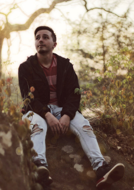 Lifestyle photography showcasing a relaxed portrait of a young man outdoors, ideal for photographers seeking inspiration.