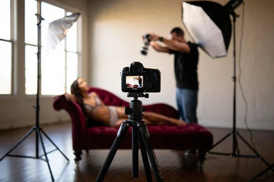 Photographer taking a photo of a model in a studio setting with camera, tripod, and lighting equipment. Quinton Stocton Photography Boudoir Services Package by Quinton Stocton Photography of Glasgow, Ky - Services > Personal Services > Beauty & Personal Care Service